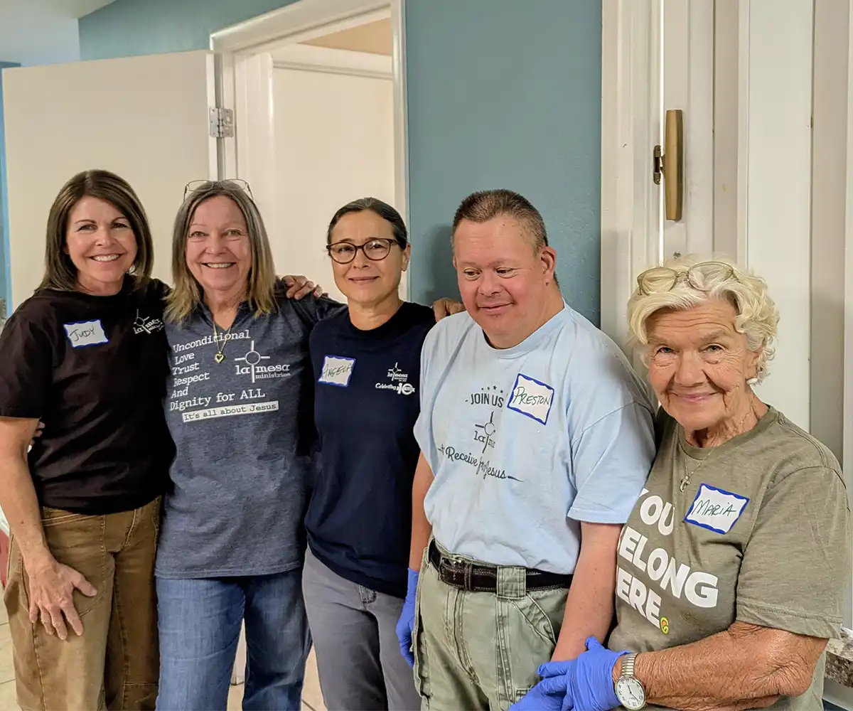 Preston standing alongside volunteers and outreach partners during a community service event