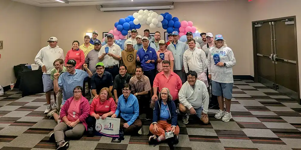 Participants gathered during an adaptive golf community event supporting inclusive recreation and connection for individuals of all abilities